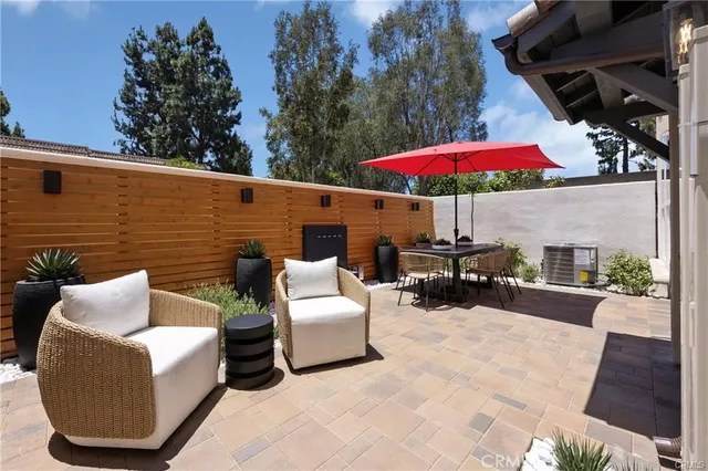 a living room with stainless steel appliances kitchen island furniture and wooden floor