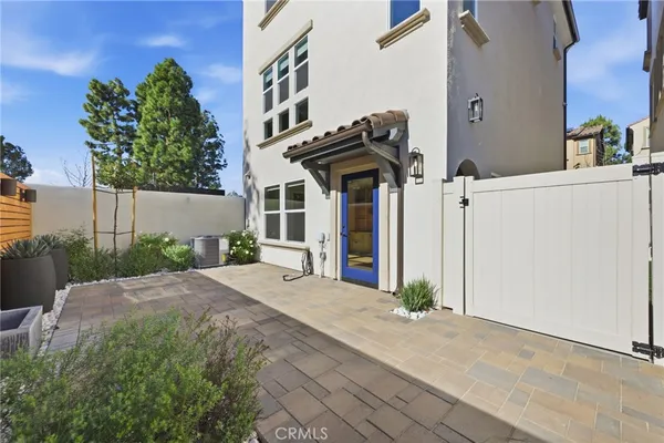 a view of a hallway with wooden floor and a bathroom