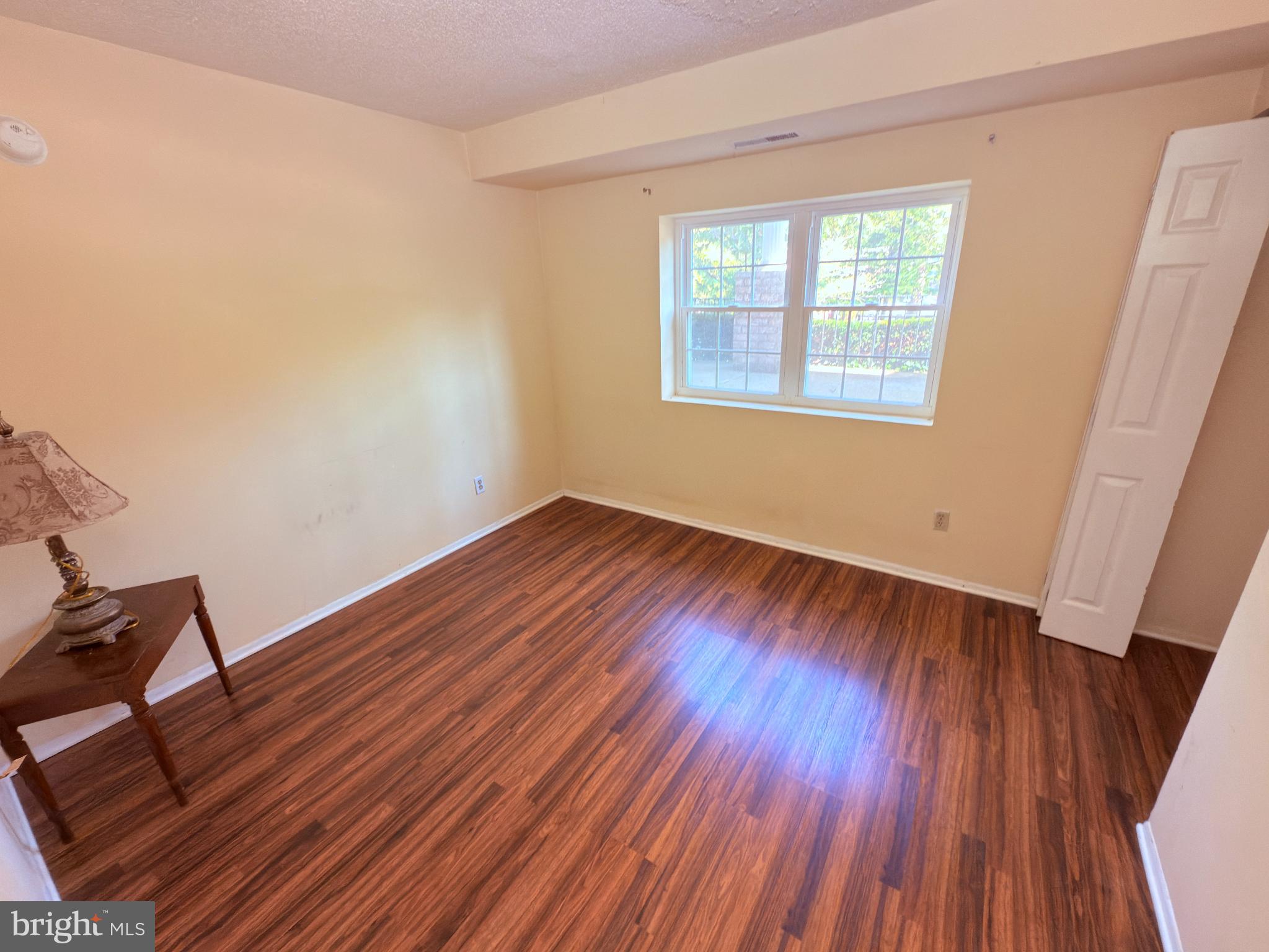 11902 A Tarragon Road, Unit A Reisterstown, MD 21136 - Photo 12 of 16 an empty room with wooden floor and windows