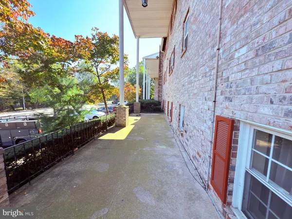 a view of an chairs and table in the back yard of a building
