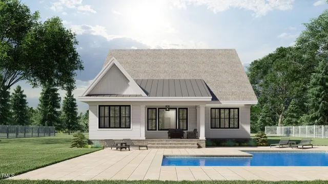 a view of house with yard and sitting area