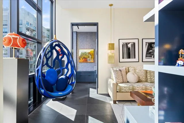 a living room with furniture a rug and entryway
