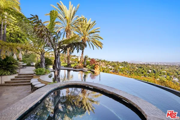 a view of swimming pool with a garden and seating area