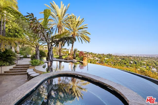 a view of swimming pool with a garden and seating area