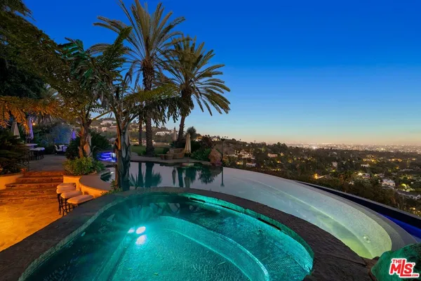 a view of a swimming pool with a table and chairs