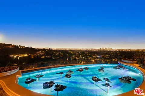 a view of a house with a swimming pool and a yard