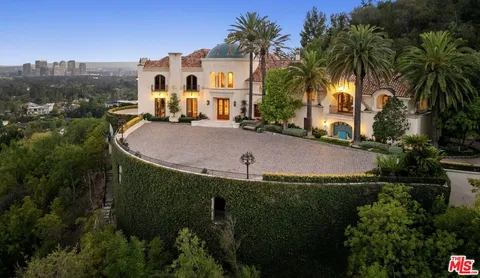 an aerial view of a house with yard swimming pool and outdoor seating