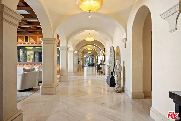a view of a living room with entryway and chandelier