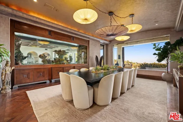 a dining room with furniture and a large window