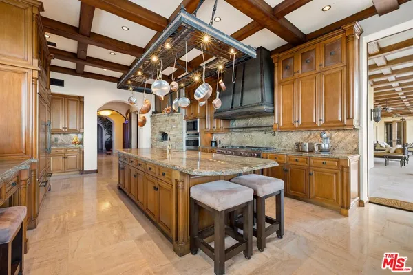 a kitchen with stainless steel appliances granite countertop a sink and cabinets