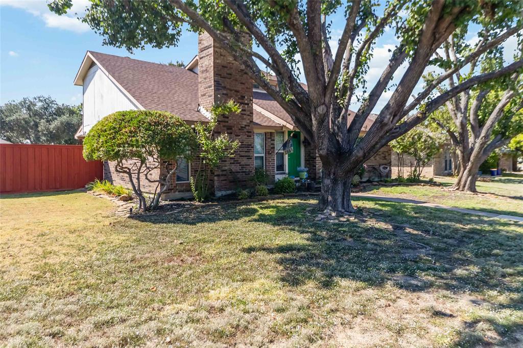 1920 Avignon Court Carrollton, TX 75007 - Photo 4 of 31 Obstructed view of property with brick siding, a chimney, and a shingled roof
