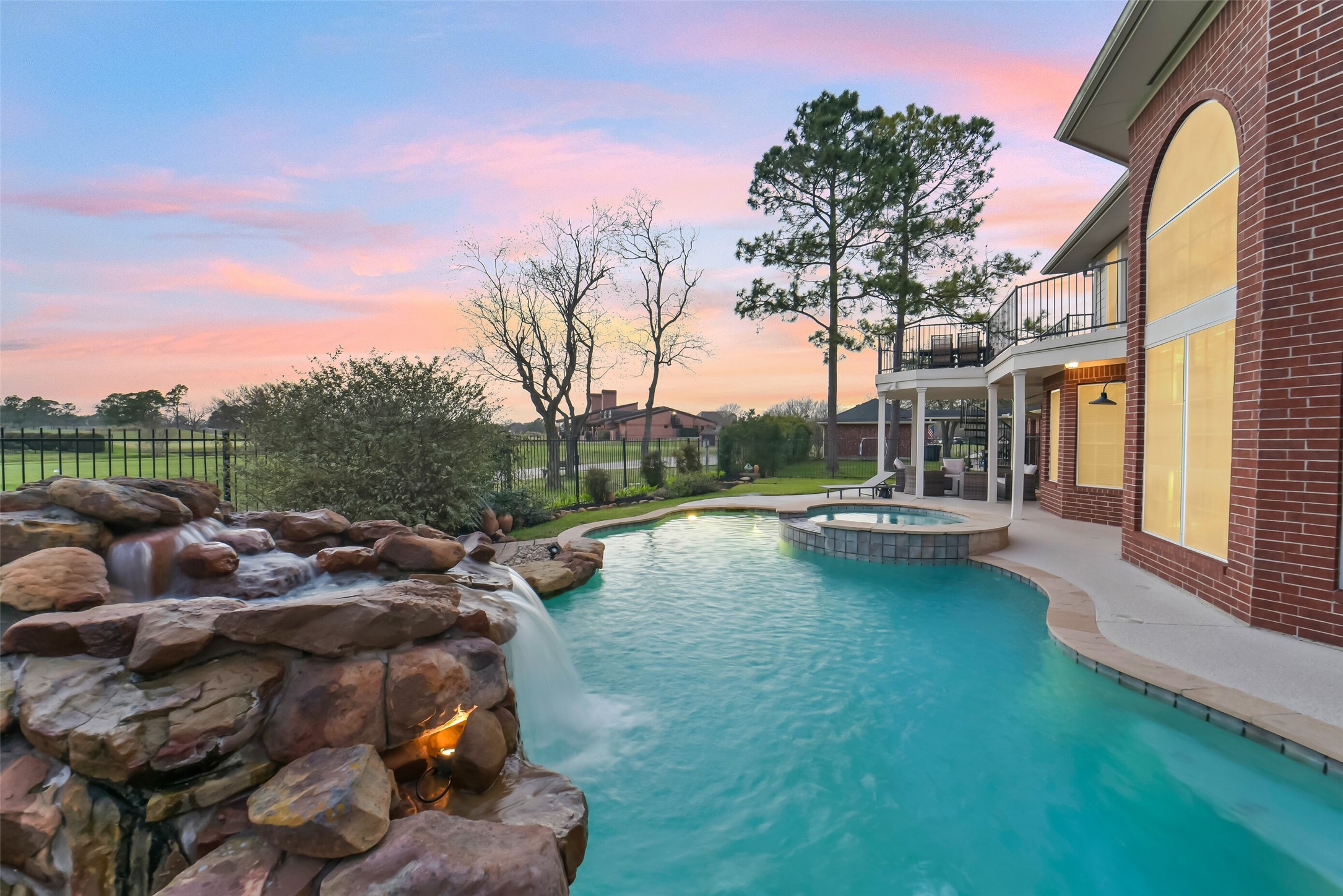 24403 Falcon Point Drive Katy, TX 77494 - Photo 6 of 32 The view of the backyard showcasing the spectacular view from the living room.