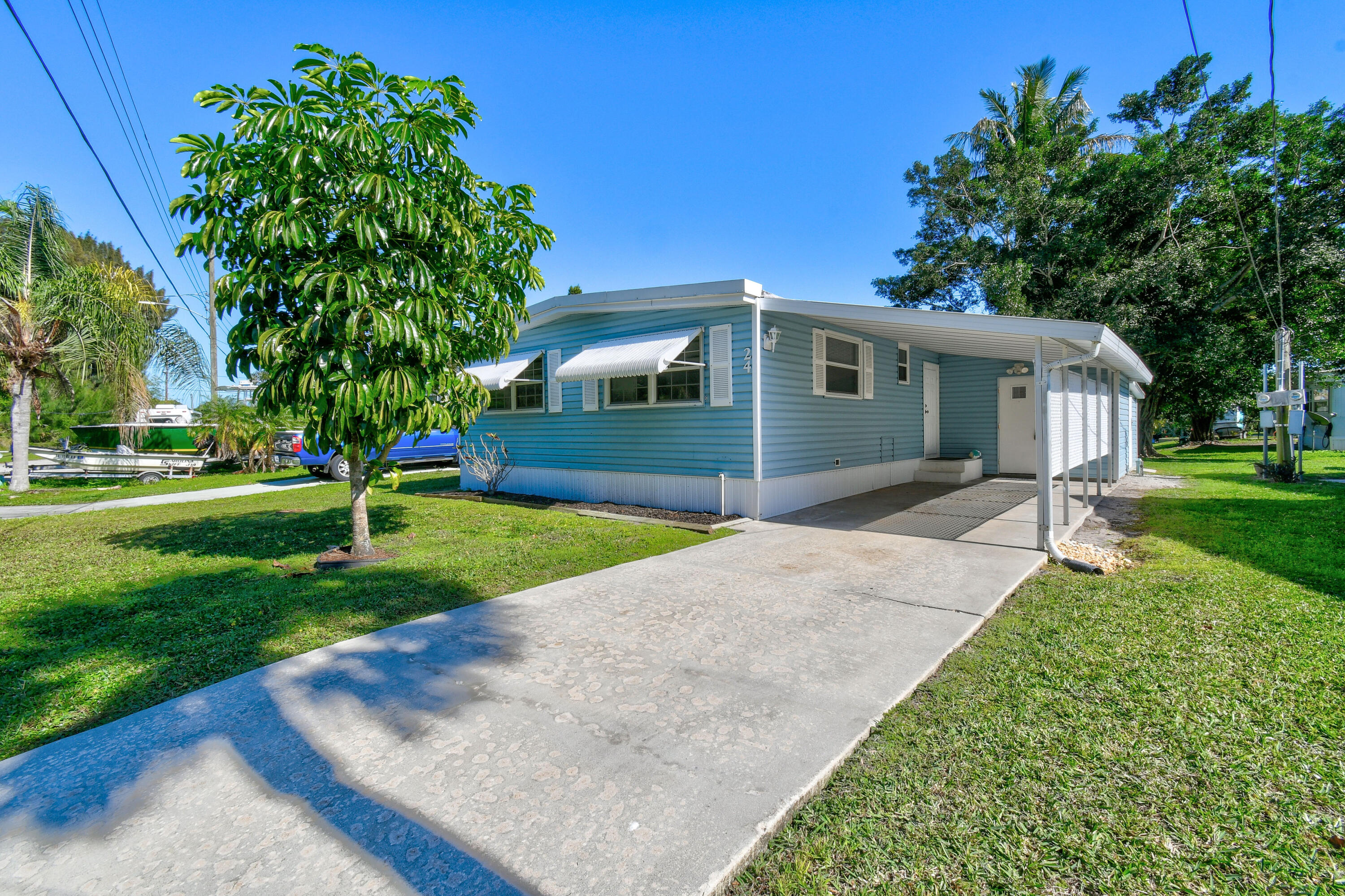 24 Southeast Fork Terrace Stuart, FL 34997 - Photo 2 of 14 a front view of house with yard and green space