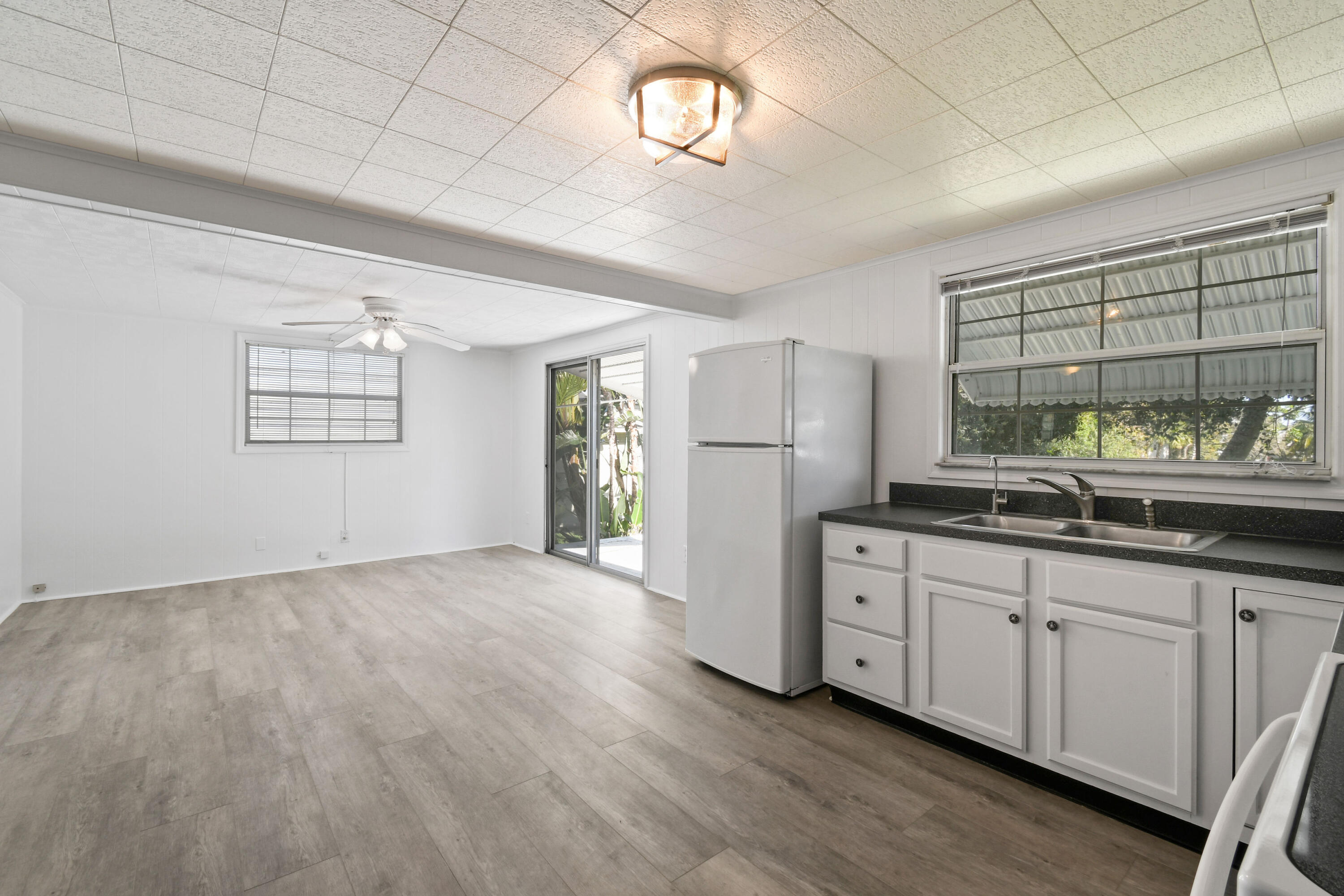 24 Southeast Fork Terrace Stuart, FL 34997 - Photo 6 of 14 a view of a kitchen with a sink dishwasher and wooden floor