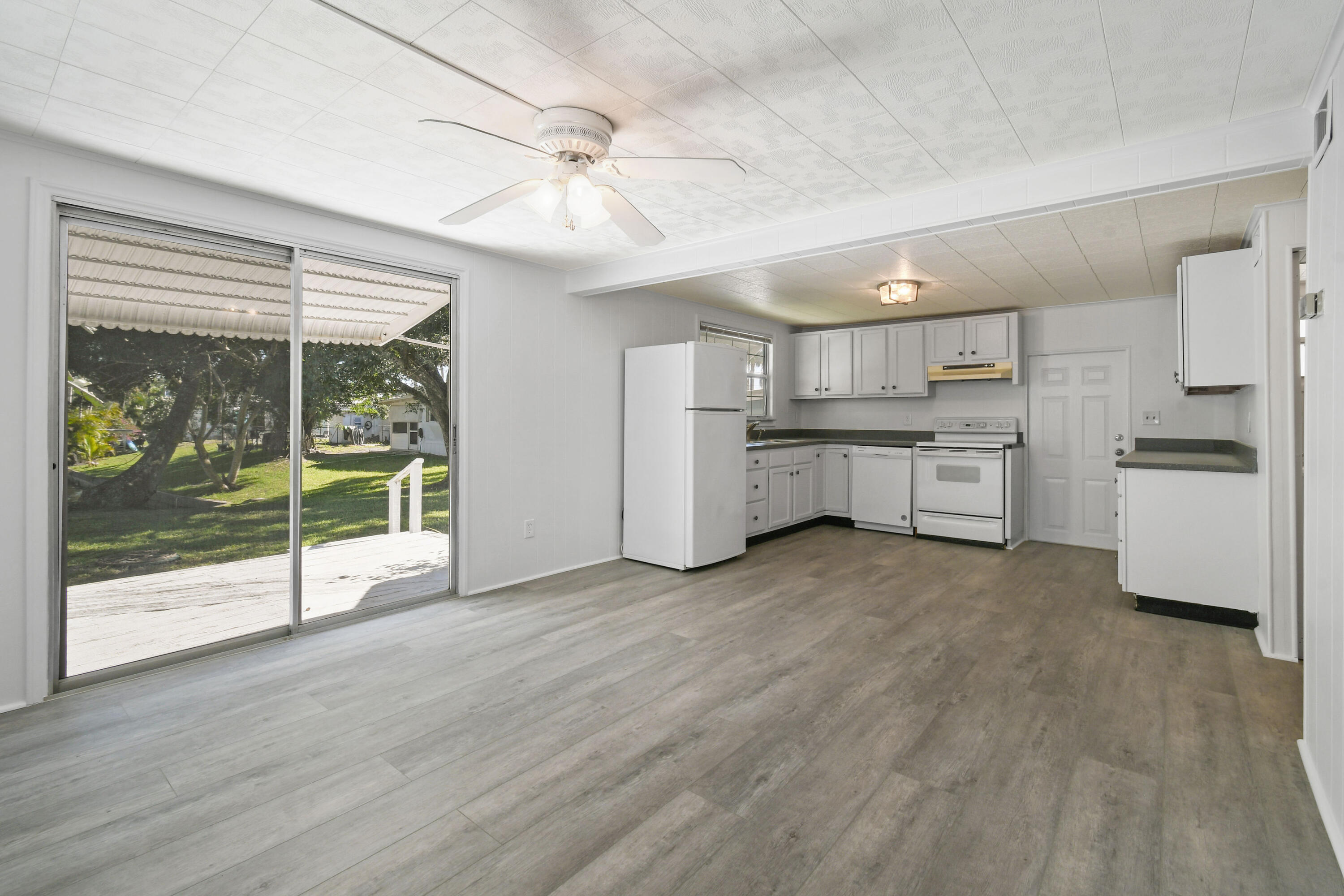24 Southeast Fork Terrace Stuart, FL 34997 - Photo 8 of 14 a large kitchen with cabinets and wooden floor