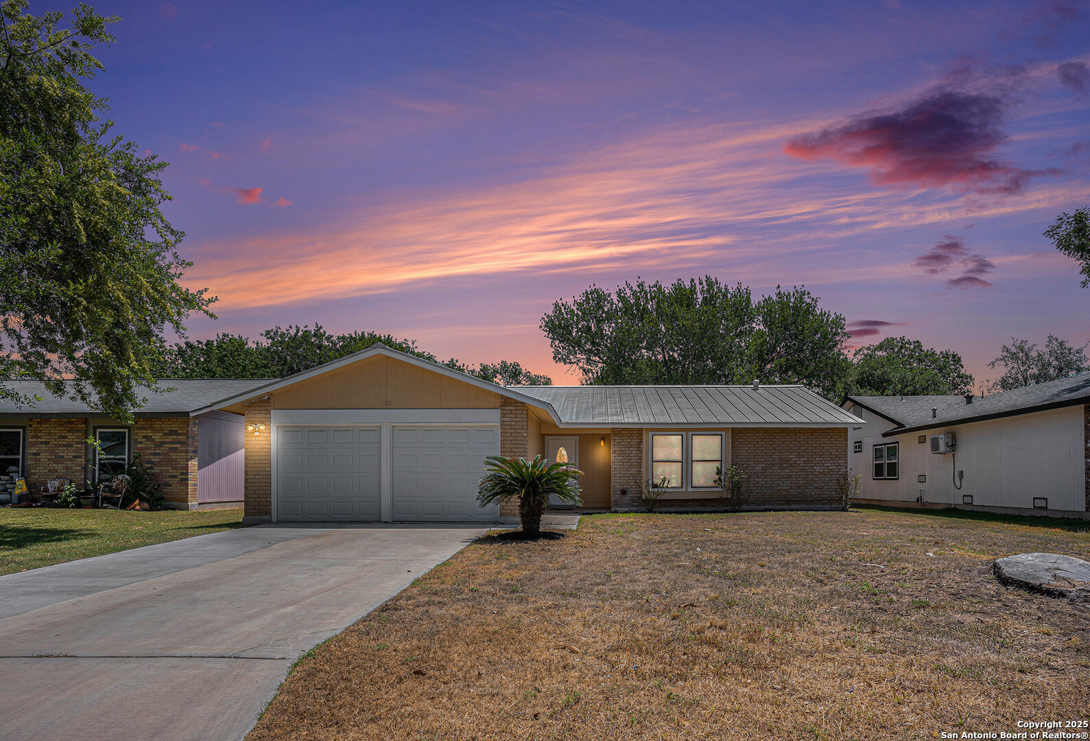 a front view of a house with a yard and a garage