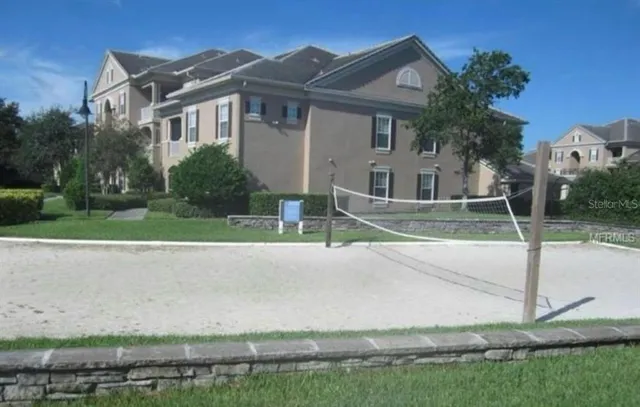 a view of a house with backyard and sitting area