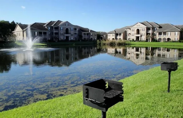 a sign that is sitting in front of a wooden bench