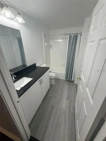 a kitchen with a sink a refrigerator and a large window