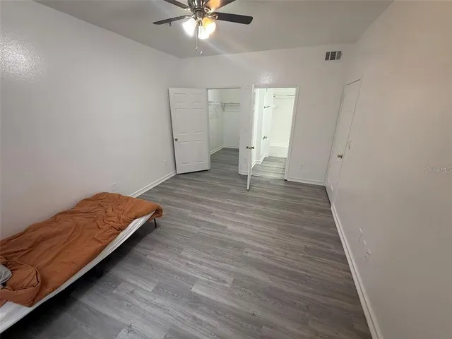 a view of room with window and wooden floor