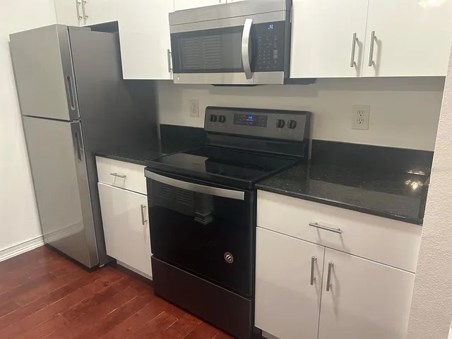 a kitchen with appliances and cabinets