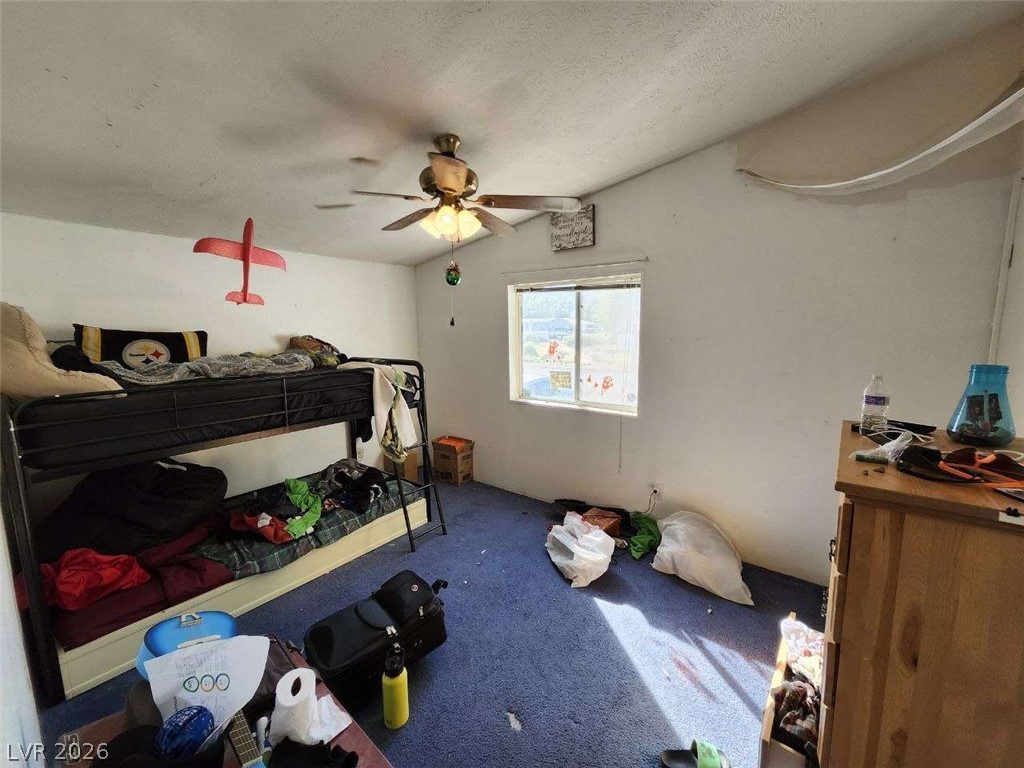 942 Holt Caliente, NV 89008 - Photo 13 of 22 A well-lit room offers vaulted ceilings and soft blue carpeting.