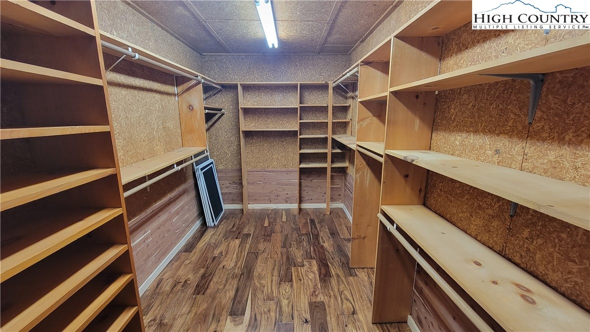 252 Goshen Creek Lane Boone, NC 28607 - Photo 11 of 31 a view of walk in closet with wooden floor and fence