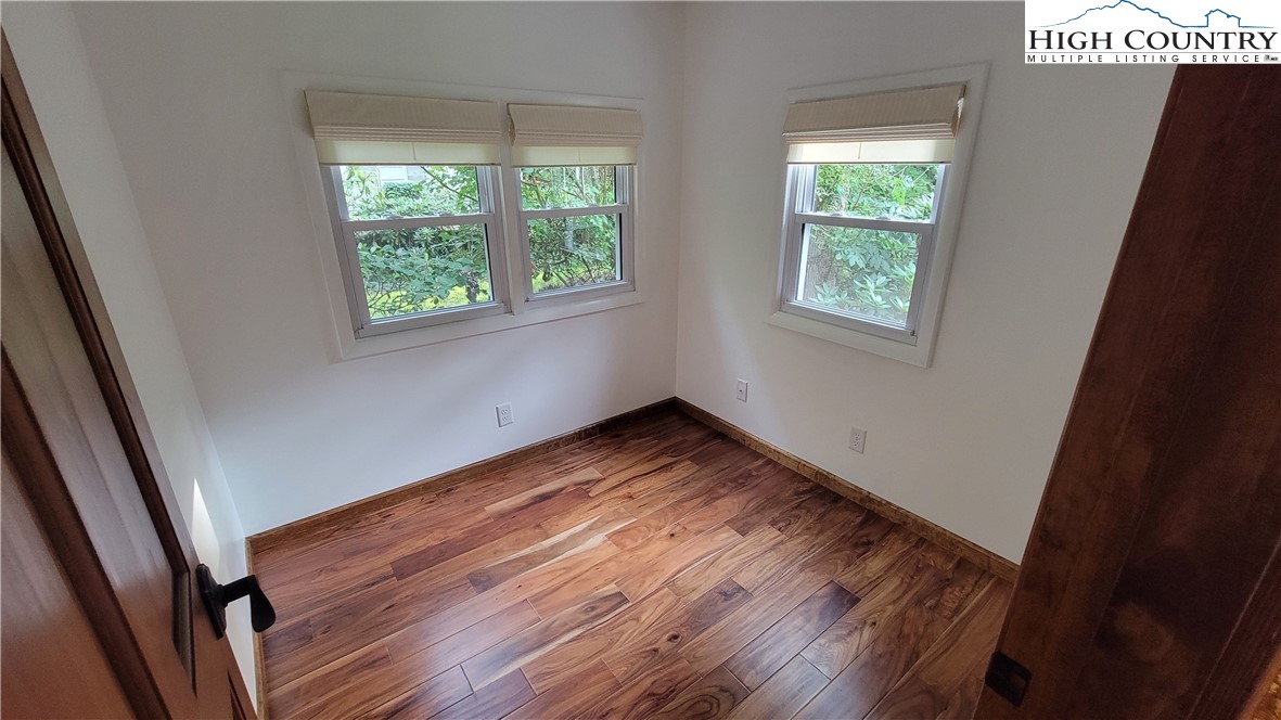252 Goshen Creek Lane Boone, NC 28607 - Photo 12 of 31 a view of empty room with wooden floor and fan