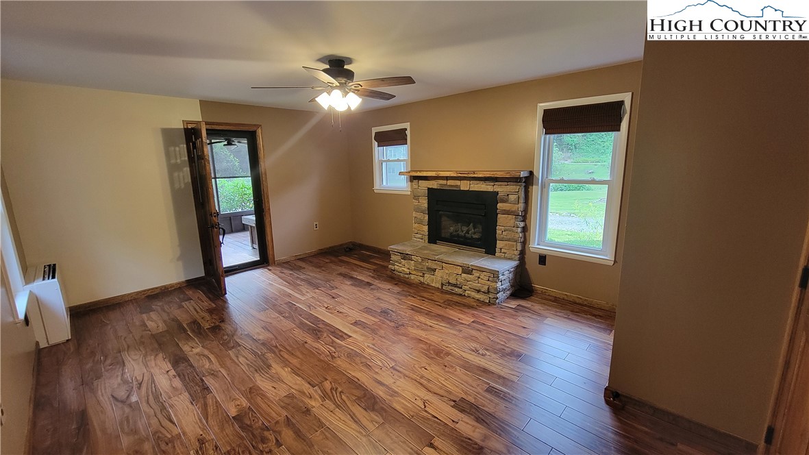 252 Goshen Creek Lane Boone, NC 28607 - Photo 2 of 31 a view of empty room with wooden floor and fan