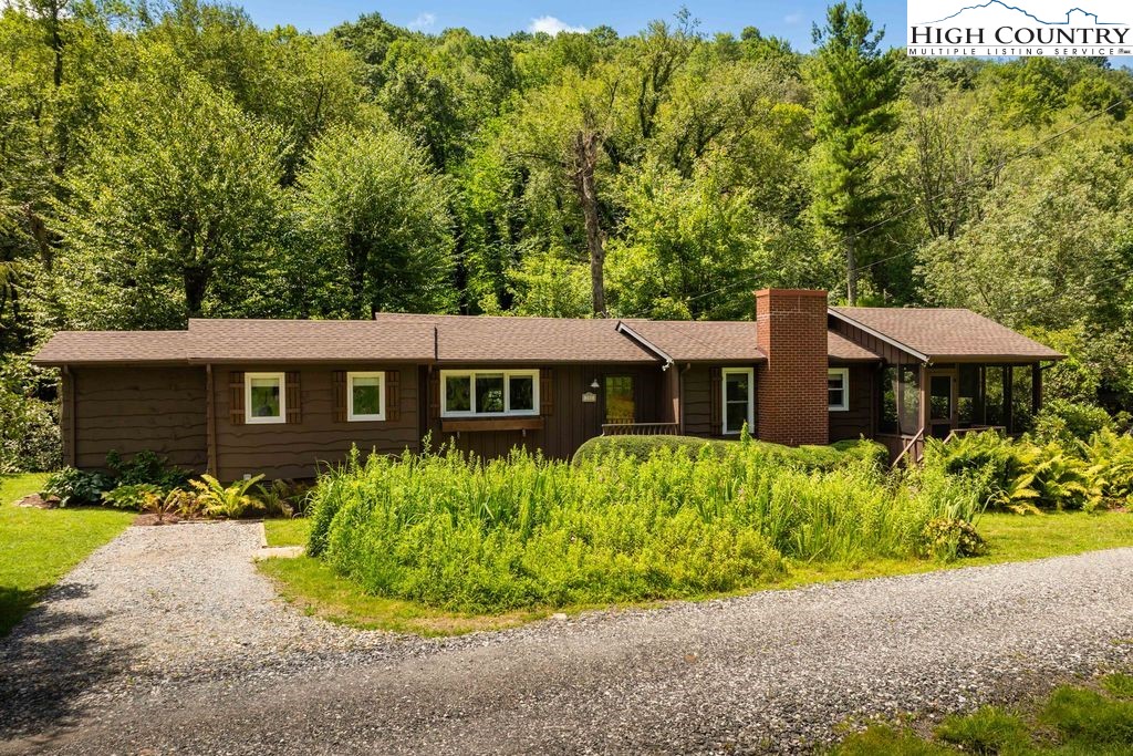 252 Goshen Creek Lane Boone, NC 28607 - Photo 29 of 31 a front view of a house with a yard and potted plants