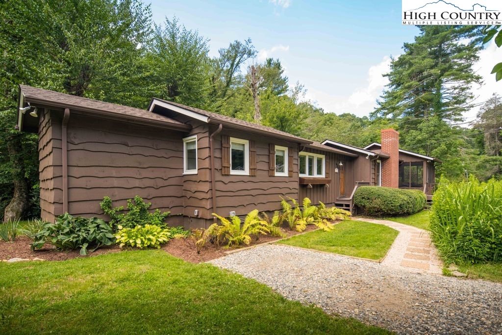 252 Goshen Creek Lane Boone, NC 28607 - Photo 30 of 31 a view of a house with a yard and plants