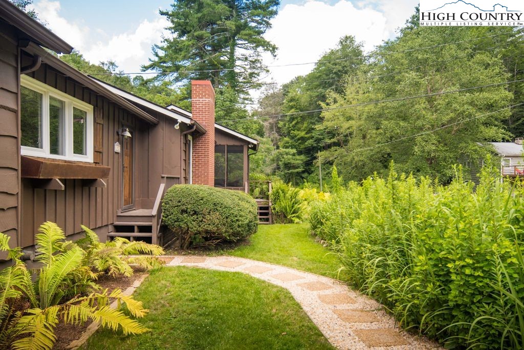 252 Goshen Creek Lane Boone, NC 28607 - Photo 31 of 31 a backyard of a house with a garden