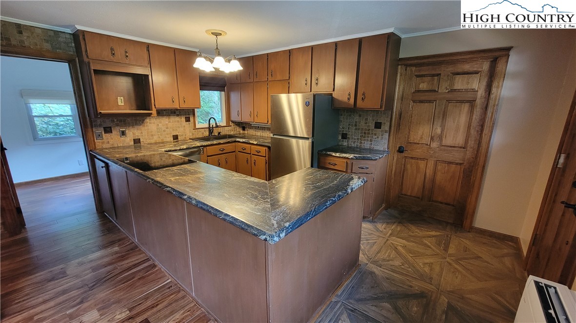 252 Goshen Creek Lane Boone, NC 28607 - Photo 4 of 31 a kitchen with stainless steel appliances granite countertop wooden cabinets a sink and a refrigerator