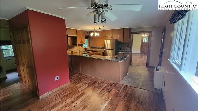 a kitchen with stainless steel appliances granite countertop a refrigerator and a sink