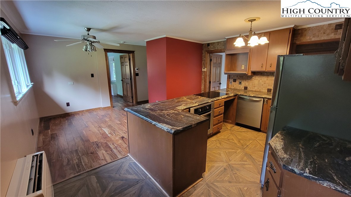 252 Goshen Creek Lane Boone, NC 28607 - Photo 8 of 31 a kitchen with stainless steel appliances granite countertop a refrigerator a stove and a sink