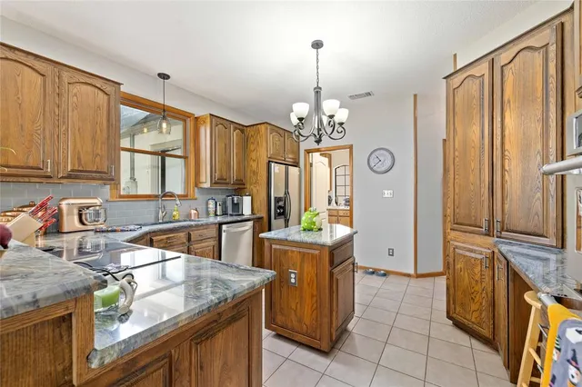 a kitchen that has a lot of cabinets in it