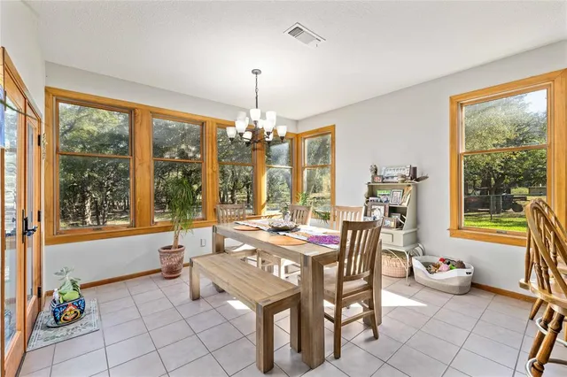 a outdoor dining space with furniture and a chandelier