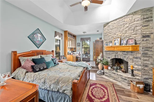 a bedroom with a bed and a fireplace