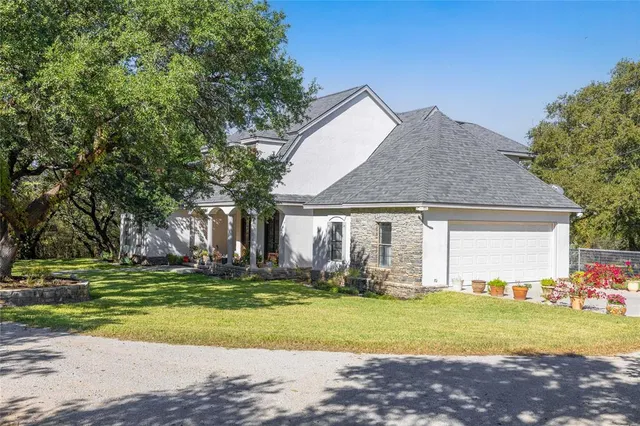 a front view of house with yard and trees