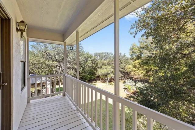 a view of a balcony with wooden floor