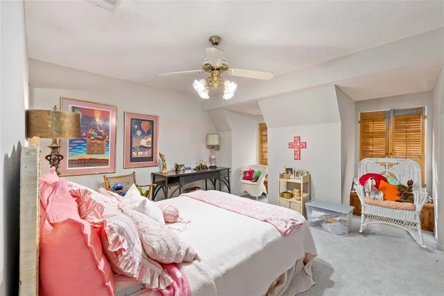 a bedroom with two beds and a chandelier