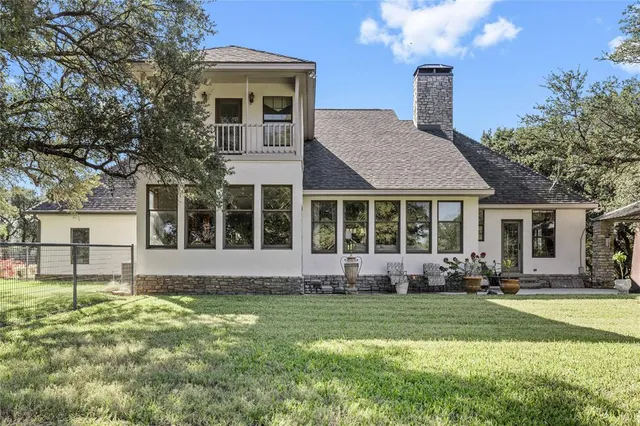 a front view of a house with a yard and outdoor seating