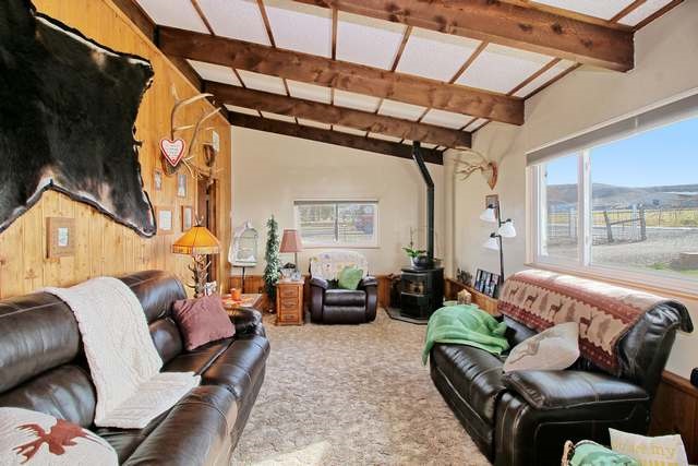 1634 O Road Loma, CO 81524 - Photo 16 of 39 a living room with furniture and a floor to ceiling window
