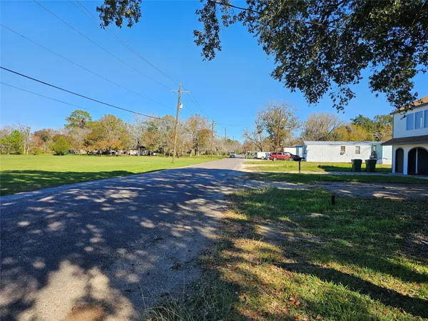 a view of a field of grass and trees