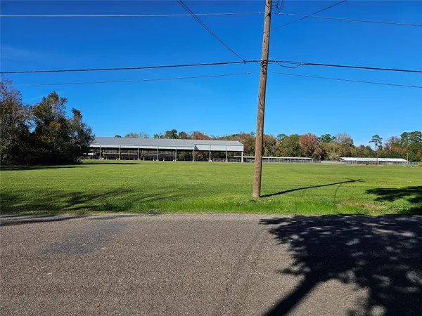 a view of a house with a big yard and potted plants