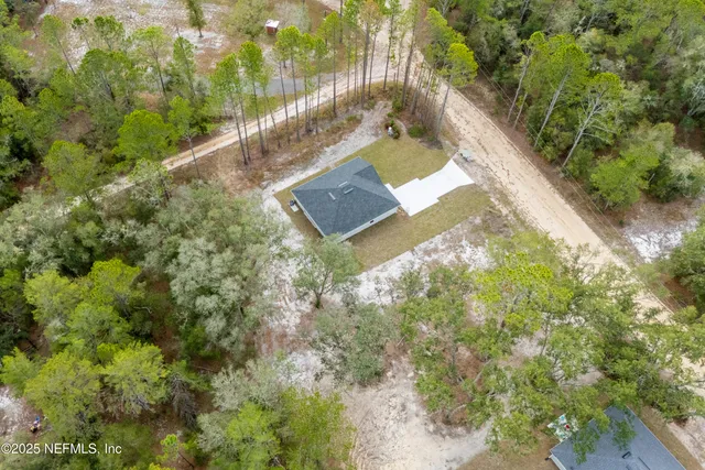 a large kitchen with stainless steel appliances granite countertop a stove a refrigerator a oven and a wooden floors