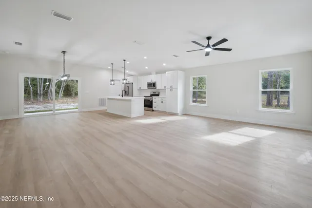 a spacious bathroom with a sink a mirror and vanity