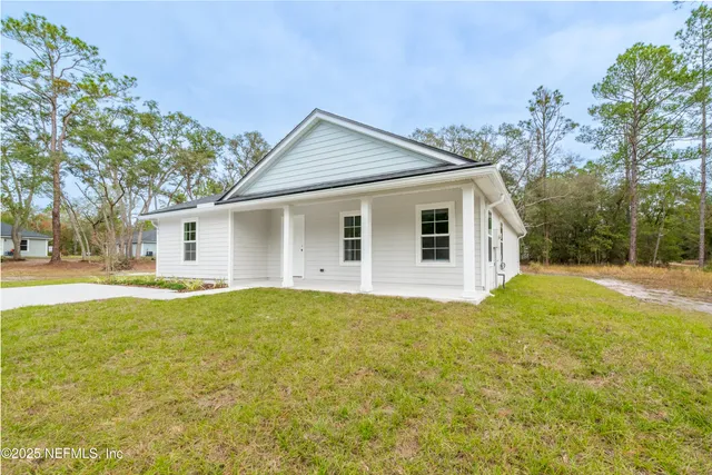 a view of a house with a yard and garage