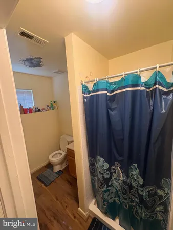 a bathroom with a toilet and a shower
