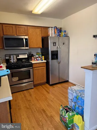 a kitchen with stainless steel appliances a stove a microwave and a refrigerator